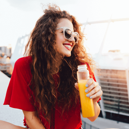 Woman enjoying a bottle of juice