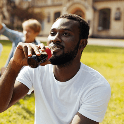 Man enjoying a bottle of Coca Cola
